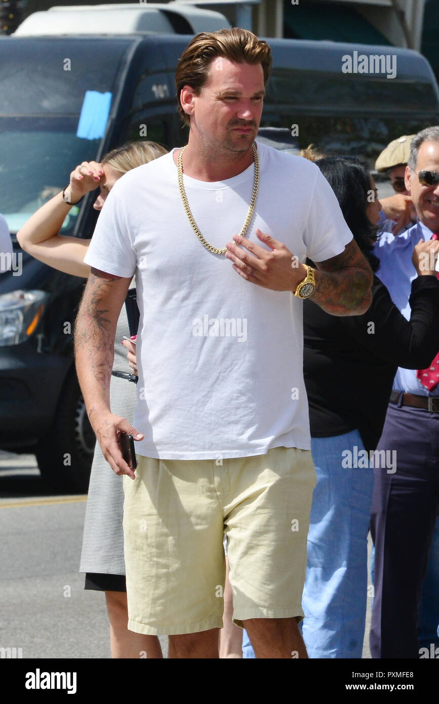 Sean Stewart out in Beverly Hills wearing a white t-shirt and a gold chain  as well as a gold Rolex watch and Nike sandals while in great spirits.  Featuring: Sean Stewart Where: