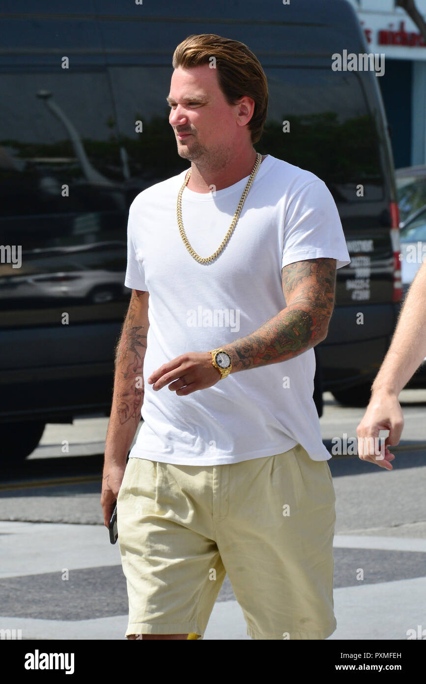 Sean Stewart out in Beverly Hills wearing a white t-shirt and a gold chain  as well as a gold Rolex watch and Nike sandals while in great spirits.  Featuring: Sean Stewart Where: