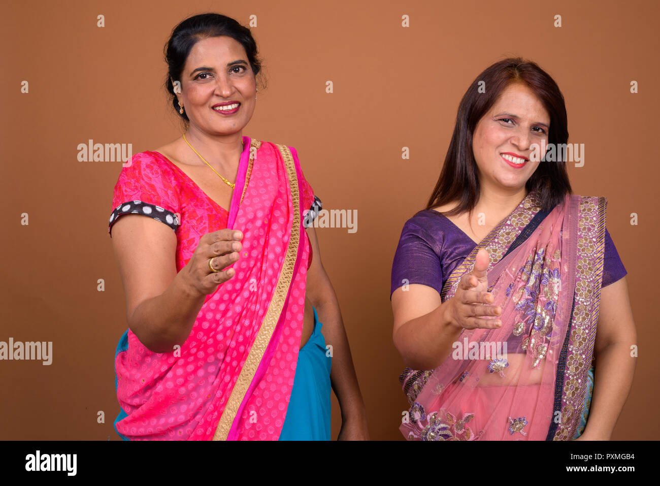 Two Indian woman greeting with handshake for agreement Stock Photo