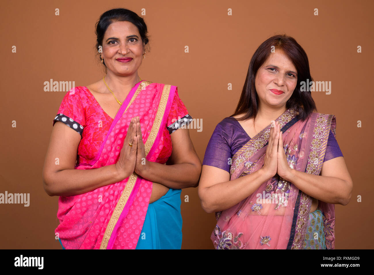 Two Indian woman wearing traditional clothes greeting Stock Photo