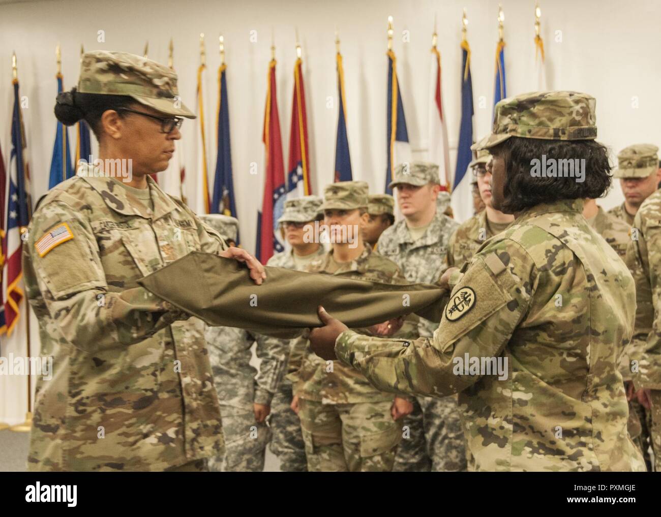 Maj. Dawn Carter-Bristol, commander, 7223rd Medical Support Unit, covers her unit guidon signifying the unit’s transfer of authority to the 7218th MSU at the Fort Bliss and Old Ironsides Museum, June 9. The 7223rd MSU, based out of Mobile, Alabama, processed over 70,000 service members, civilians and contractors in support of the Soldier Resilience and Readiness Center at Fort Bliss. Stock Photo