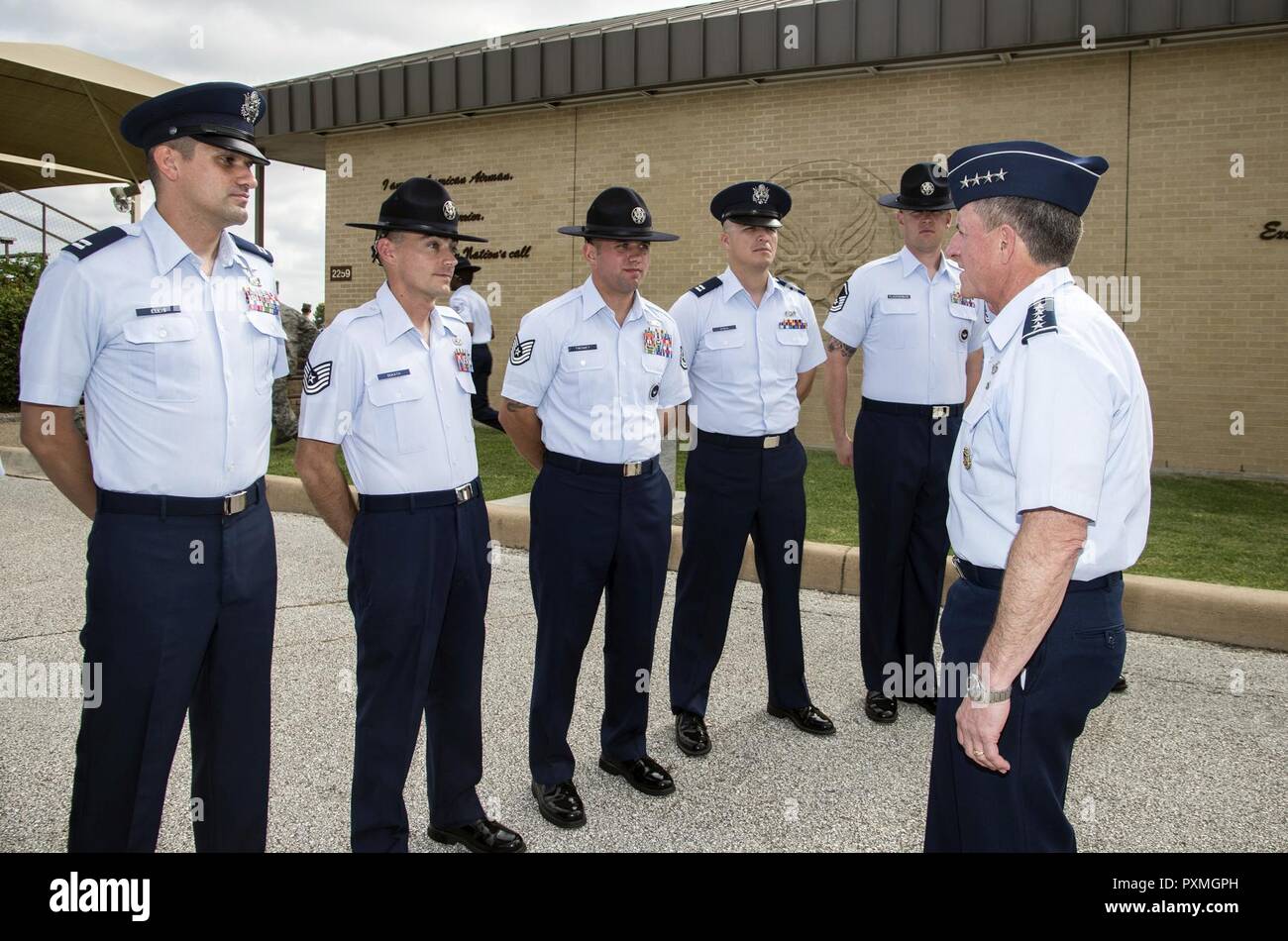 Air Force Chief of Staff Gen. David Goldfein speaks with military training instructors after a basic military training graduation June 16, 2017, at Joint Base San Antonio-Lackland, Texas. Goldfein toured various JBSA-Lackland facilities and met many 37th Training Wing Airmen during his two-day visit. Every enlisted Airmen begins their Air Force career at basic military training. JBSA-Lackland is often referred to as the 'Gateway to the Air Force,' graduating about 39,000 Airmen annually. BMT is one of the missions of the 37th Training Wing, the largest training wing in the United States Air Fo Stock Photo