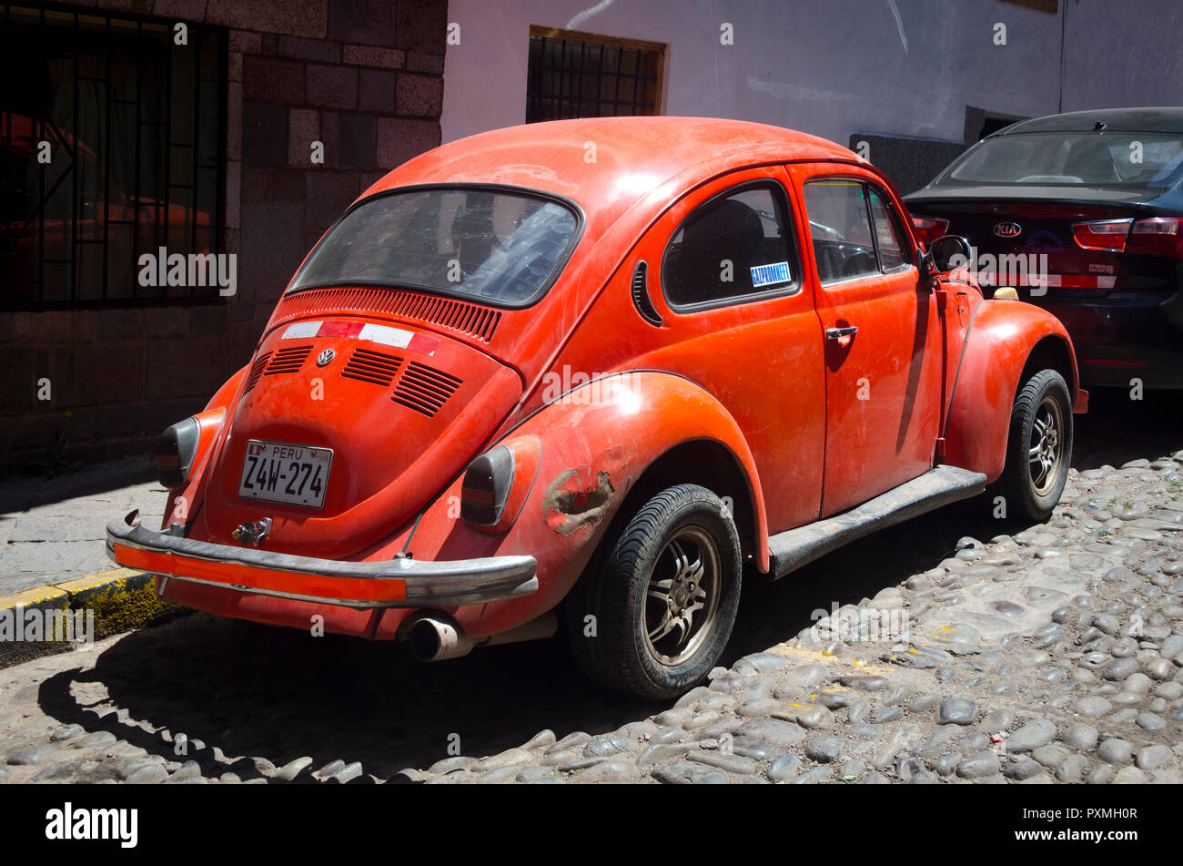 Orange Volkswagon 'Beetle' car, Cuzco, Peru Stock Photo