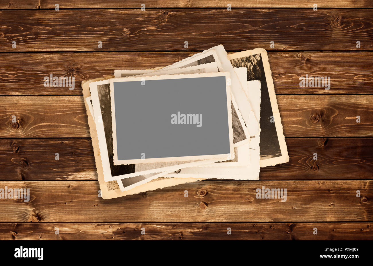 Old photos pile on wood background Stock Photo