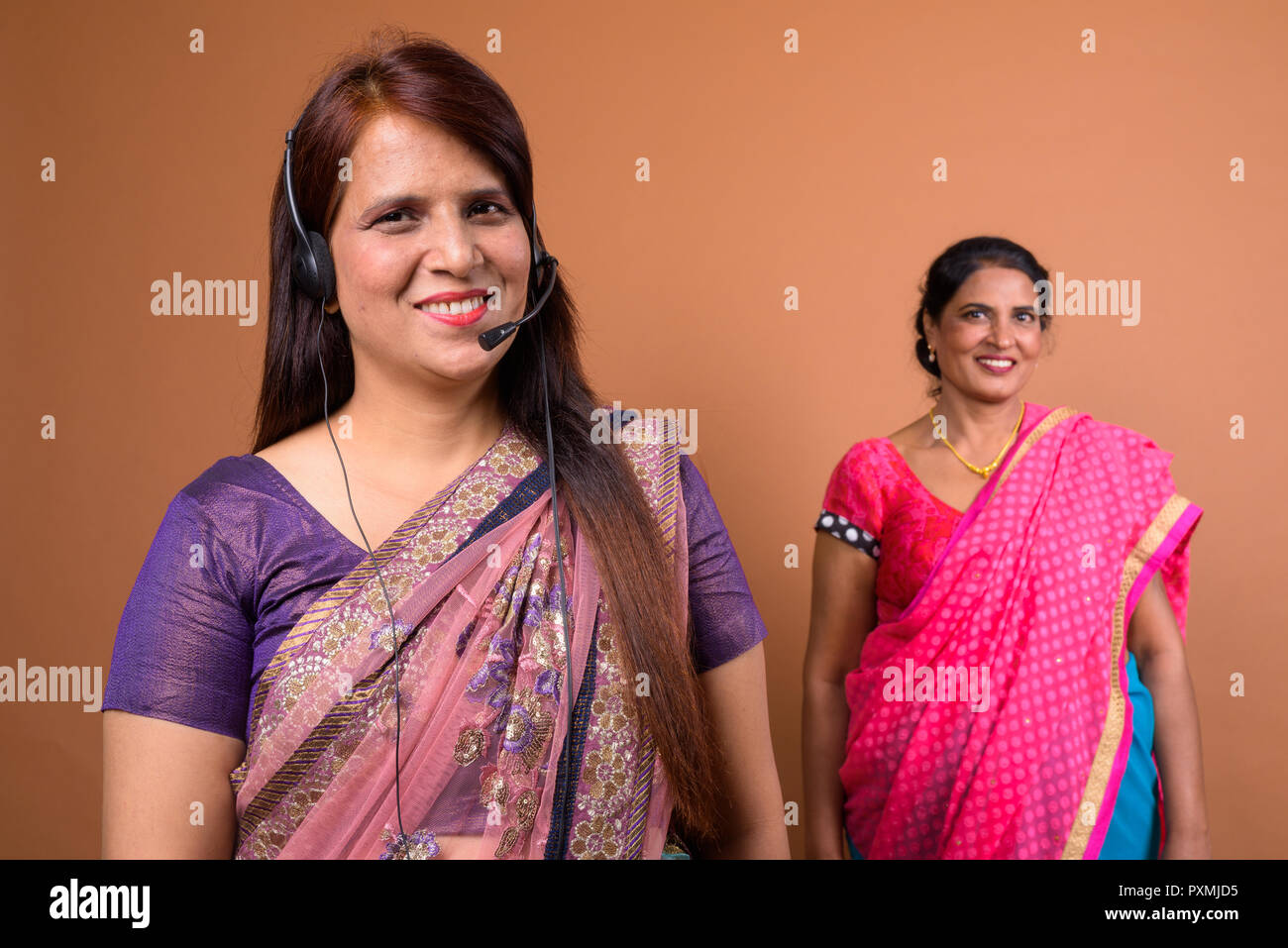 Portrait of happy Indian woman call center representative wearing headset Stock Photo