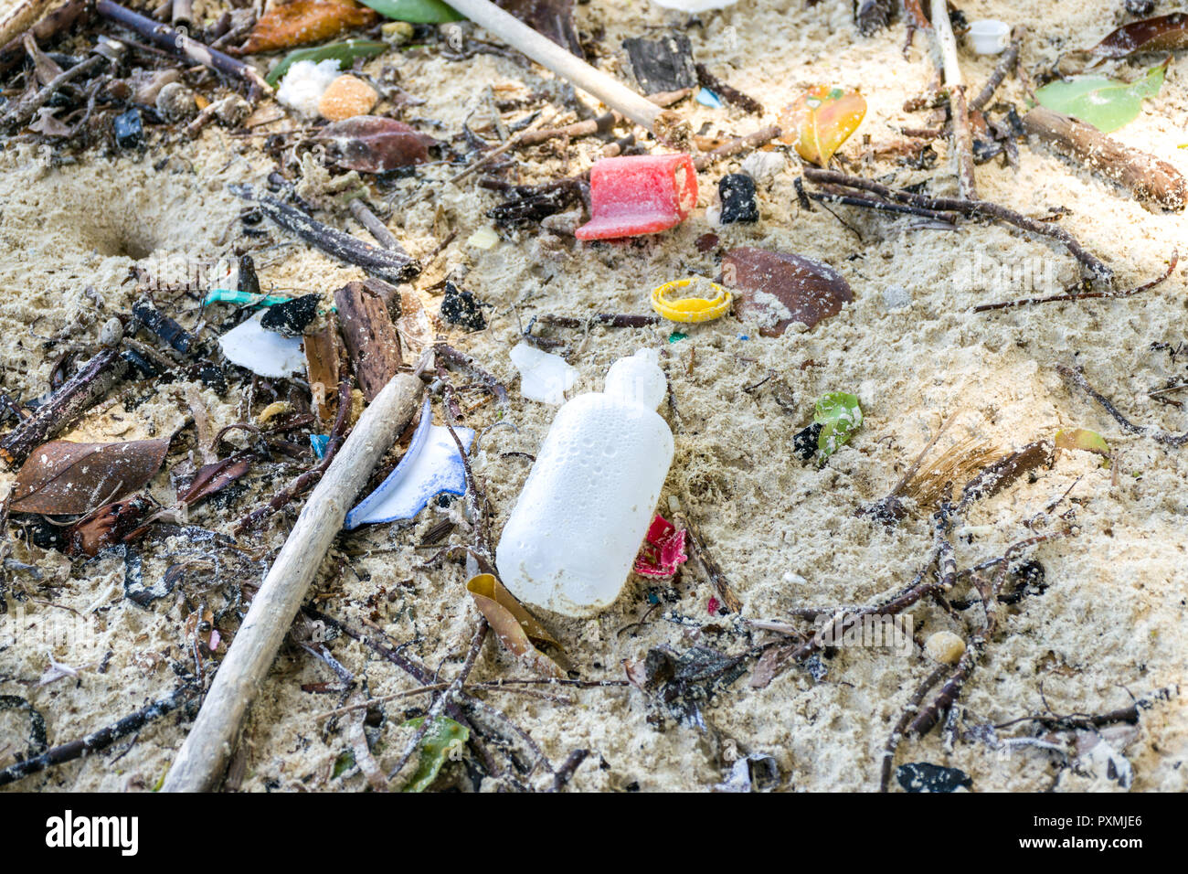 A plastic bottle and other rubbish washed up on a sandy beach Stock ...
