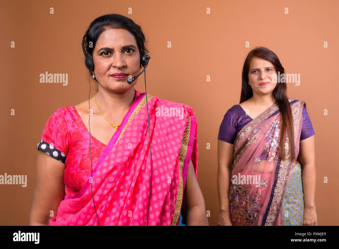 Portrait of mature Indian woman call center representative wearing headset Stock Photo