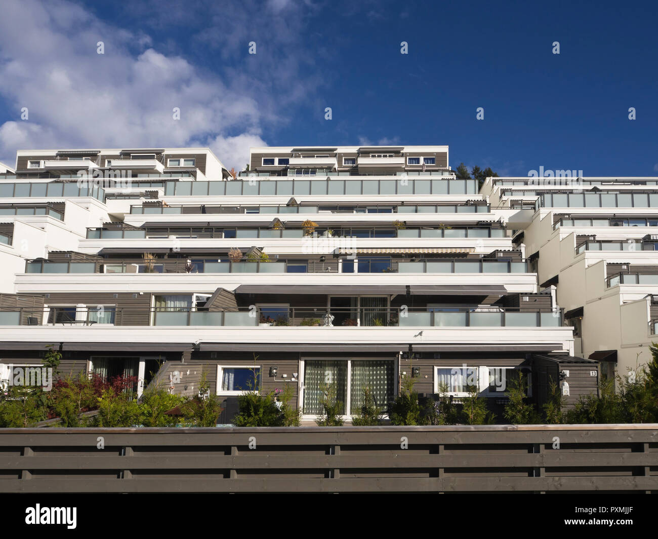 Terraced apartment block in the suburb of Holmlia in Oslo Noway, popular architecture with large terraces and flowerboxes Stock Photo