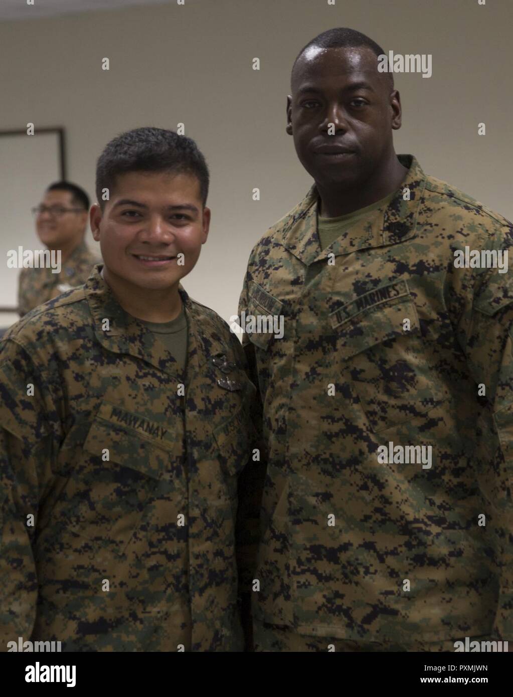 Ensign Freddie B. Mawanay, left, the medical detachments officer in charge, assigned to 3rd Medical Battalion, 3rd Marine Logistics Group, III Marine Expeditionary Force, and 1st Sgt. Derrick Benbow, right, senior enlisted advisor of 3rd Law Enforcement Battalion, III Marine Headquarters Group, III MEF, enjoys the celebration for the 119th birthday of the hospital corpsman rate at Camp Mujuk, Pohang, Republic of Korea, June 17, 2017. Marines from Bravo Company, 3rd Law Enforcement Battalion, III Marine Headquarters Group, III MEF and Corpsmen with 3rd Med Bn, 3rd MLG, III MEF came together to  Stock Photo