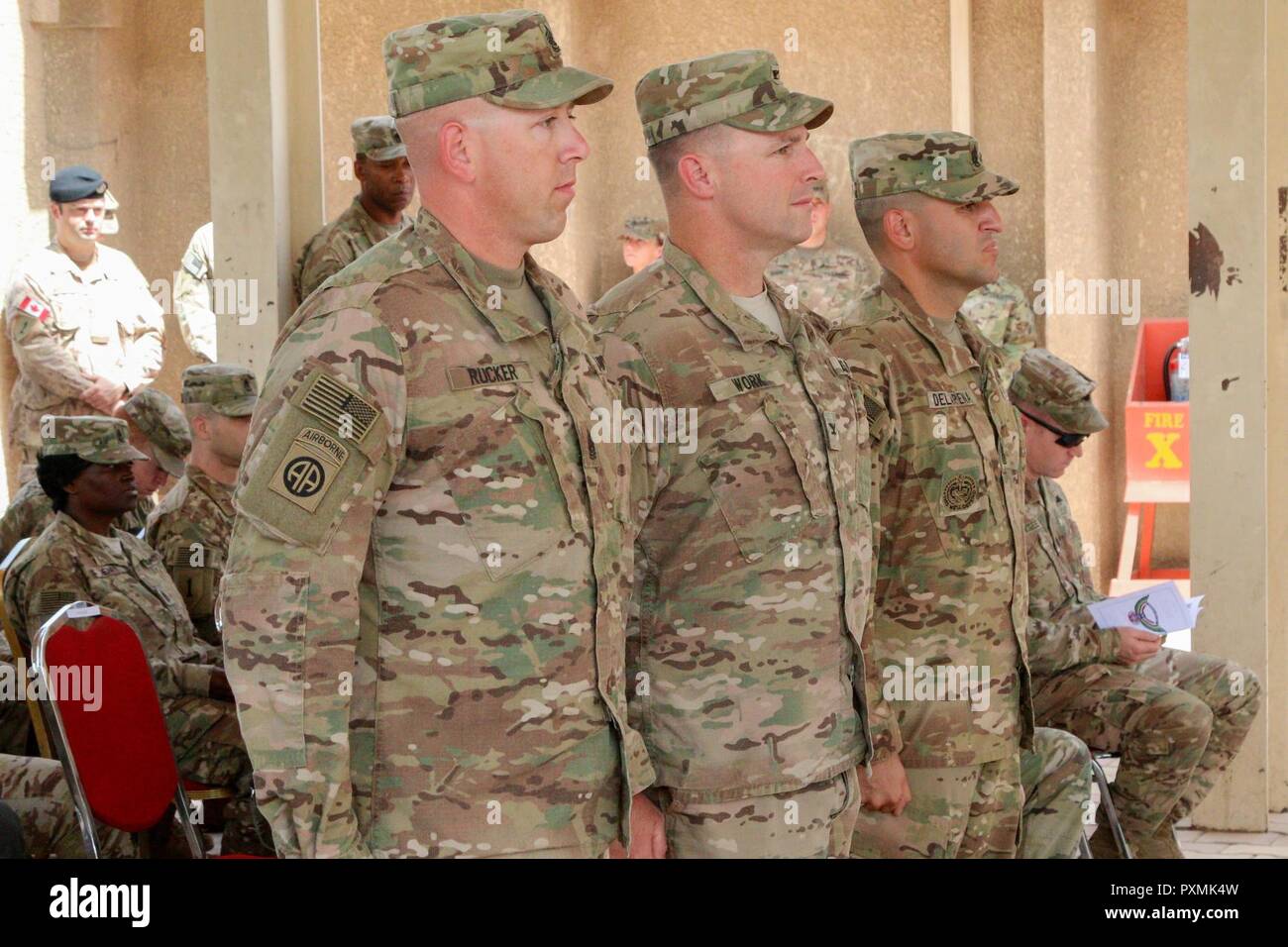 Outgoing Command Sgt. Maj. Mitchell Rucker (left), Col. Pat Work, commander  of the 2nd Brigade Combat Team, 82nd Airborne Division, and incoming  Command Sgt. Maj. Randolph Delapena stand at attention during the