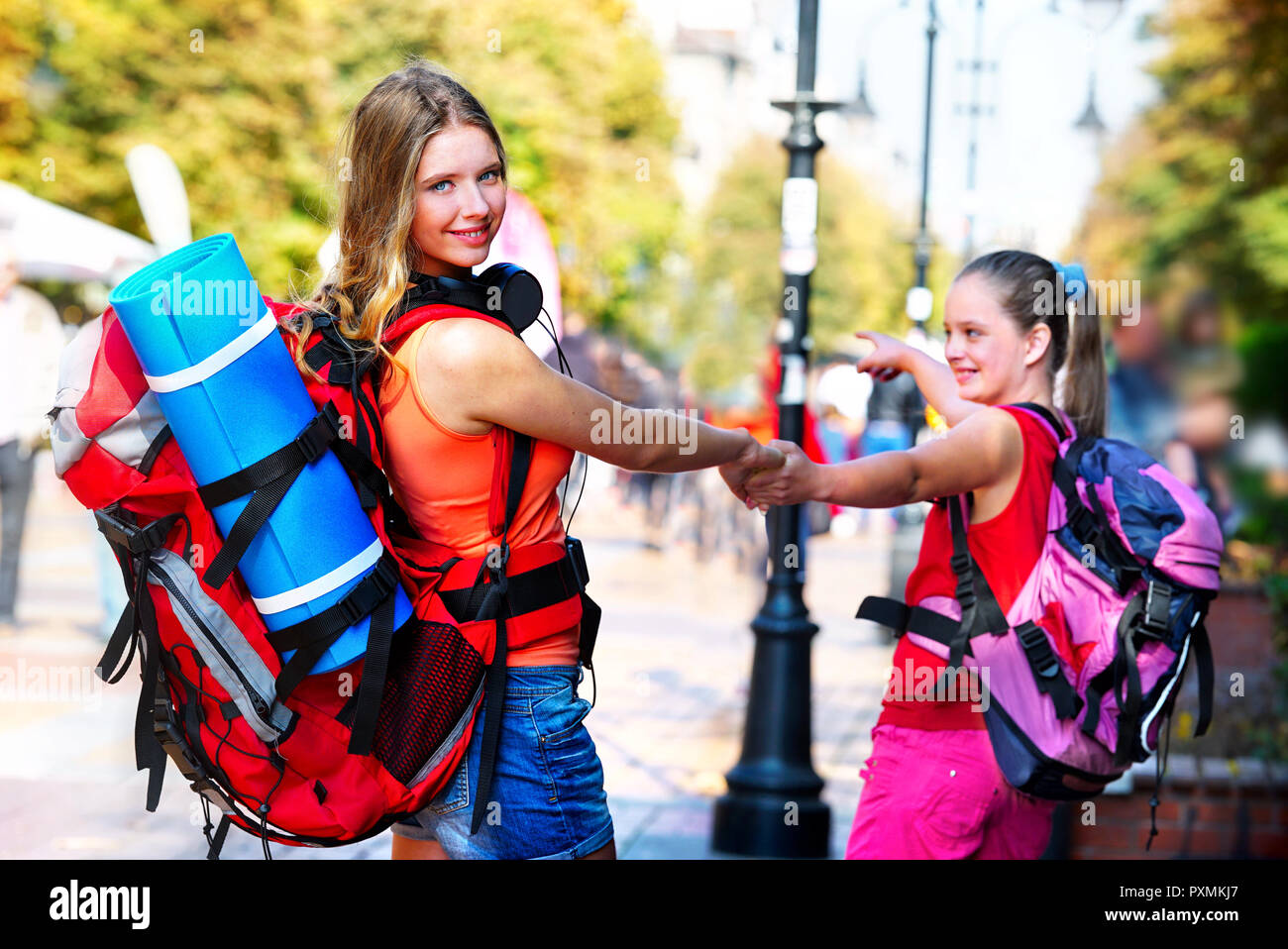 Traveller girls with backpack wallking on European cultural city Stock Photo