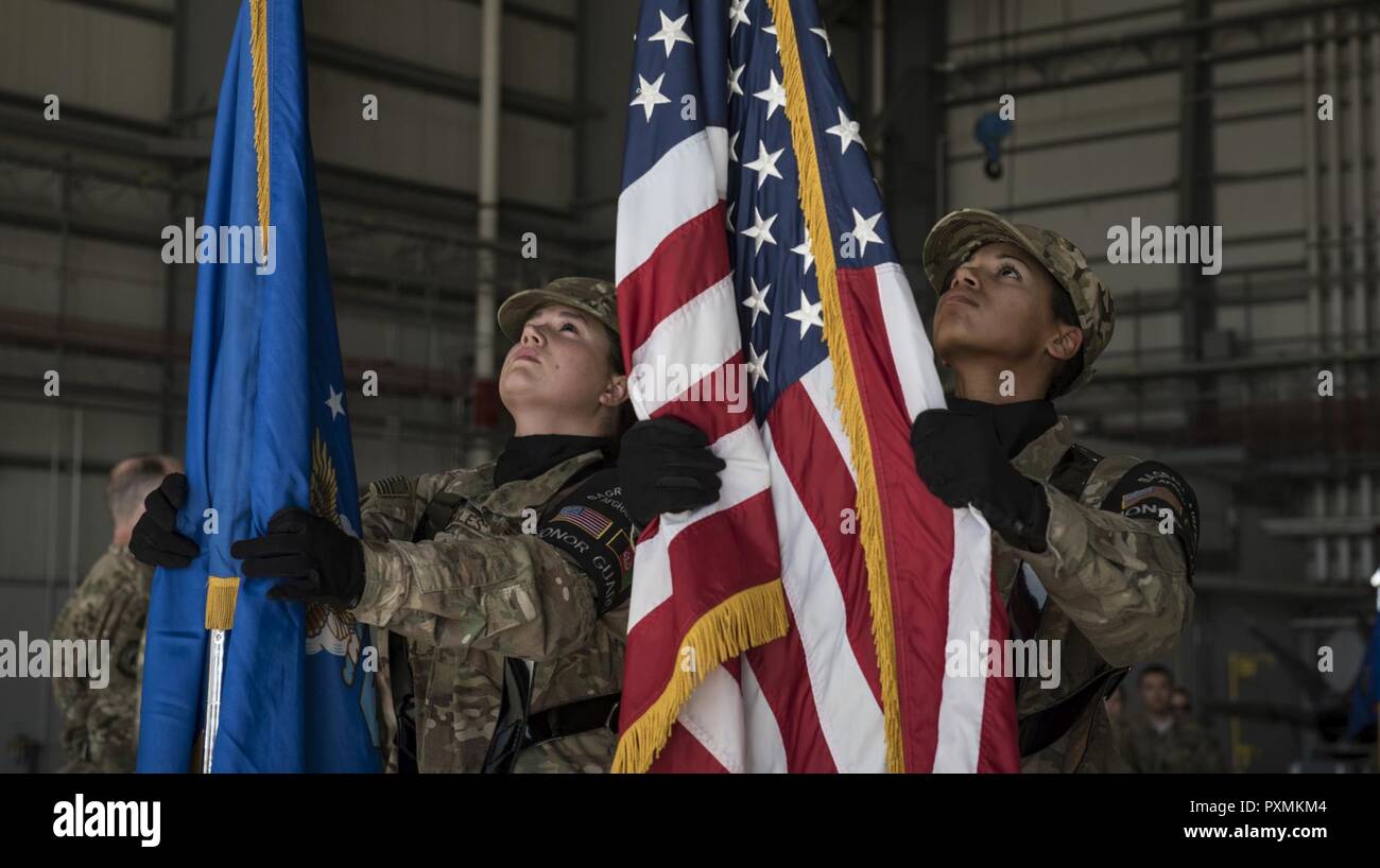 Bagram Honor Guard members set the American and U.S. Air Force flag during the 455th Expeditionary Maintenance Group change of command ceremony at Bagram Airfield, Afghanistan, June 17, 2017. During the ceremony, Col. Eric Soto relinquished command of the 455th EMXG to Col. Tim Trimmell. Stock Photo