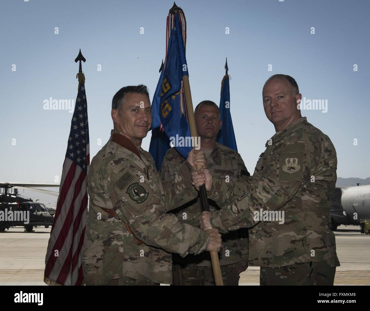 Col. Tim Trimmell, the incoming 455th Expeditionary Maintenance Group commander, receives the 455th EMXG guidon from Brig. Gen. Craig Baker, the 455th Air Expeditionary Wing commander, officially granting him command of the 455th EMXG during a change of command ceremony at Bagram Airfield, Afghanistan, June 17, 2017. Trimmell previously served as the United States Air Forces Europe-United Kingdom deputy director. Stock Photo