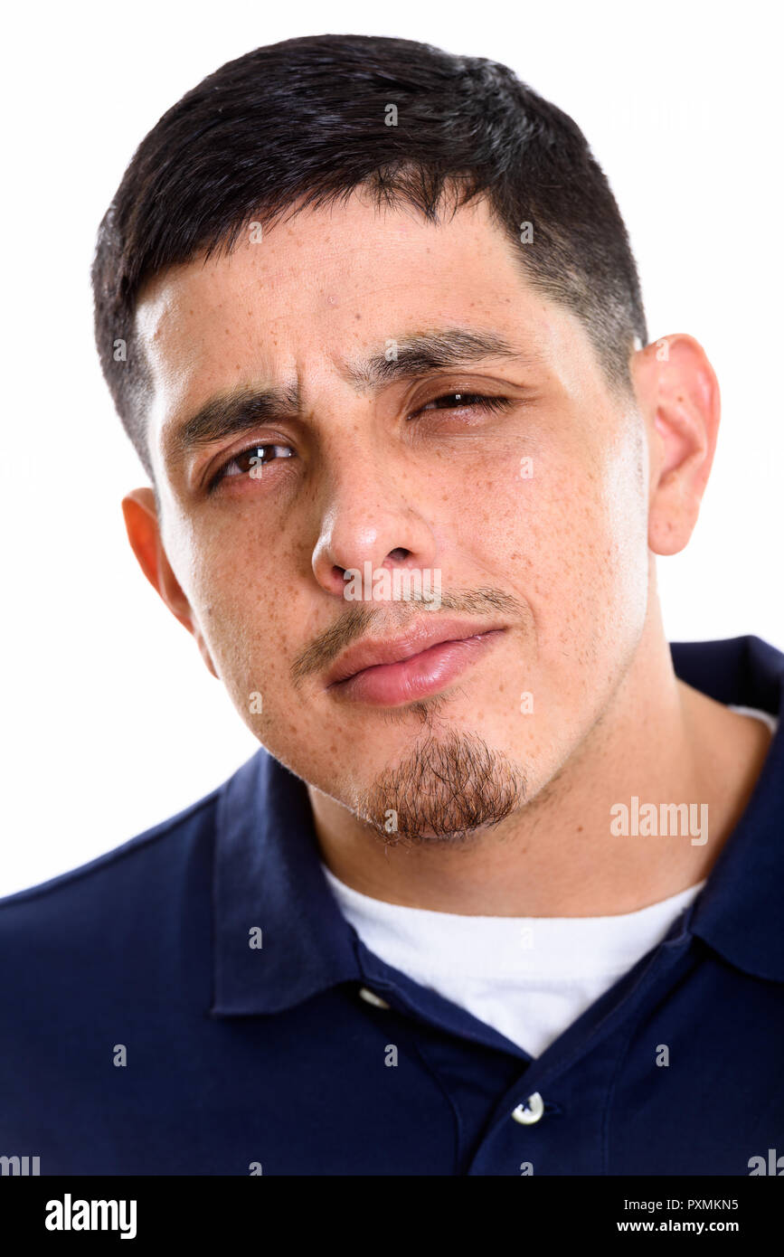 Face of young Hispanic man looking confused Stock Photo