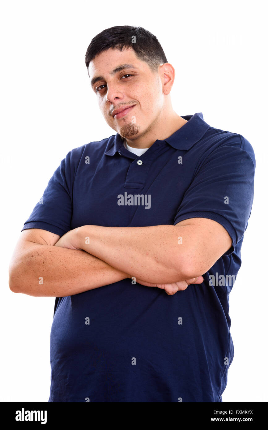 Studio shot of young Hispanic man with arms crossed Stock Photo