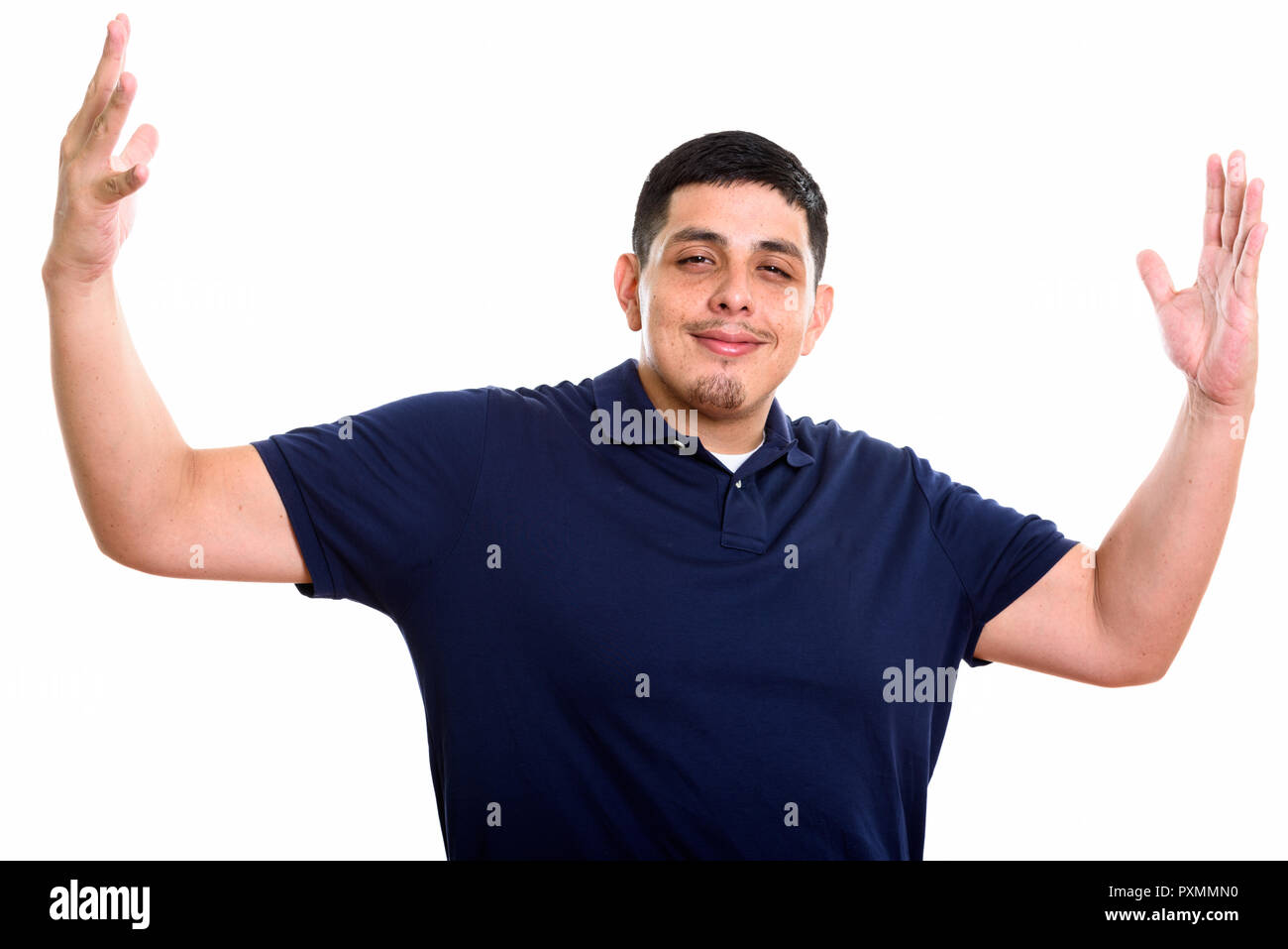 Studio shot of young Hispanic man with open arms Stock Photo