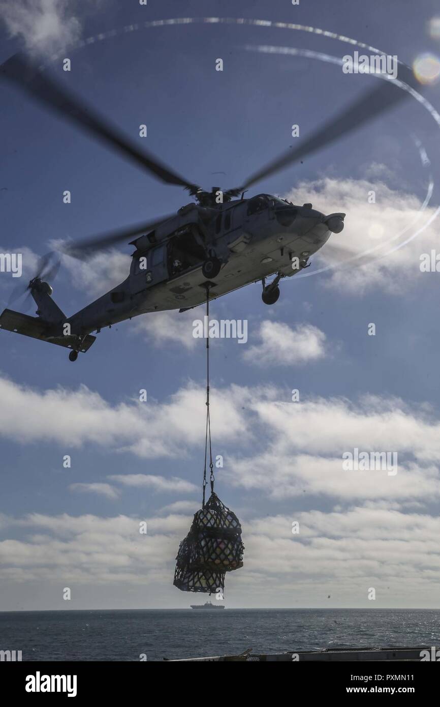 PACIFIC OCEAN – An MH-60 Seahawk lowers supplies onto the flight deck ...