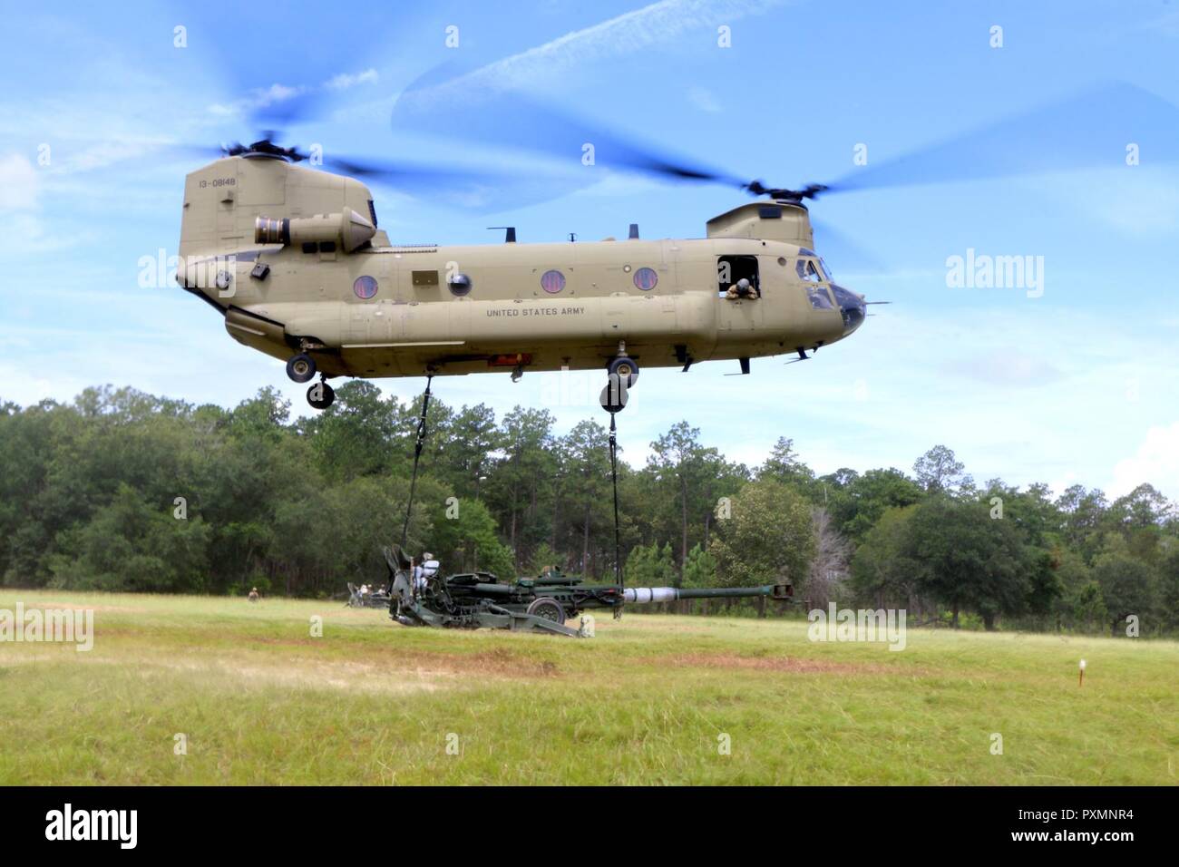 Charlie Battery, 1st Battalion, 118th Field Artillery Regiment,  48th Infantry Brigade Combat Team, 3rd Infantry Division, conducts sling load operations with the 3rd Combat Aviation Brigade, 3rd ID, at Fort Stewart, Ga., June 19, 2017.       The sling load training is part of eXportable Combat Training Capabilities (XCTC) rotation 17-04.  XCTC is an exercise that supports the Army’s Associated Units Pilot Program by bringing active, National Guard and U.S. Army Reserve units together to strengthen the total Army. Stock Photo