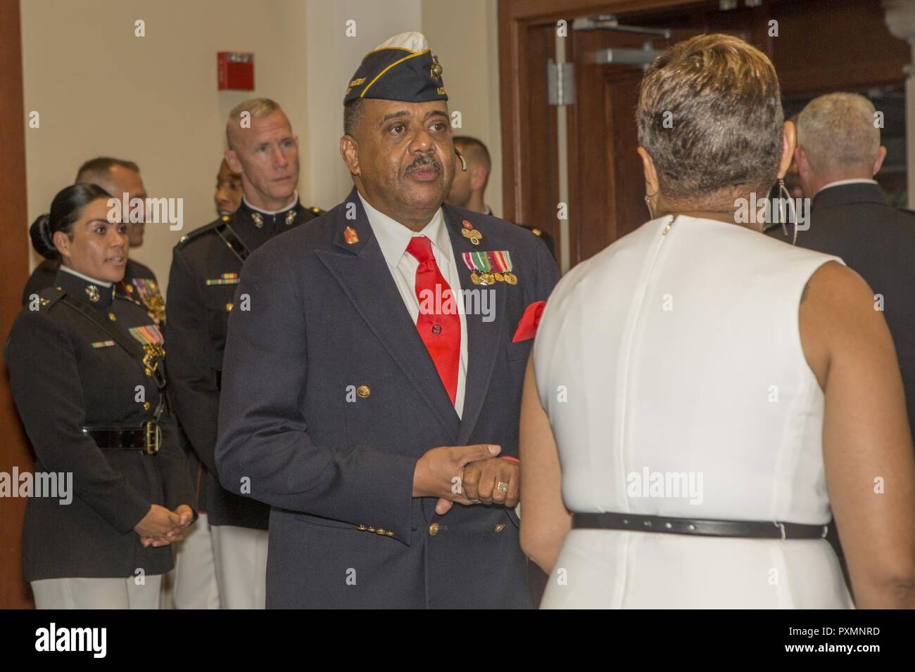 Retired U.S. Marine Corps Master Gunnery Sgt. Joseph H. Geeter, past national president, National Montford Point Marine Association, interacts with guests during an evening parade reception in Colonel Truman W. Crawford Hall at Marine Barracks Washington, Washington, D.C., June 16, 2017. Evening parades are held as a means of honoring senior officials, distinguished citizens and supporters of the Marine Corps. Stock Photo