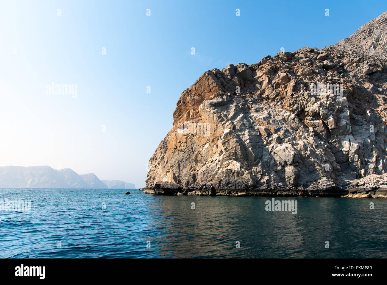 Scenic seaside surrounded by desert rocks in Khasab, Musandam Oman Stock Photo