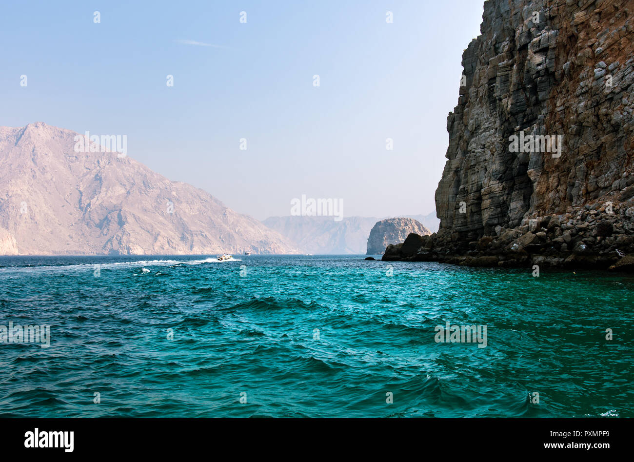 Scenic seaside surrounded by desert rocks in Khasab, Musandam Oman Stock Photo