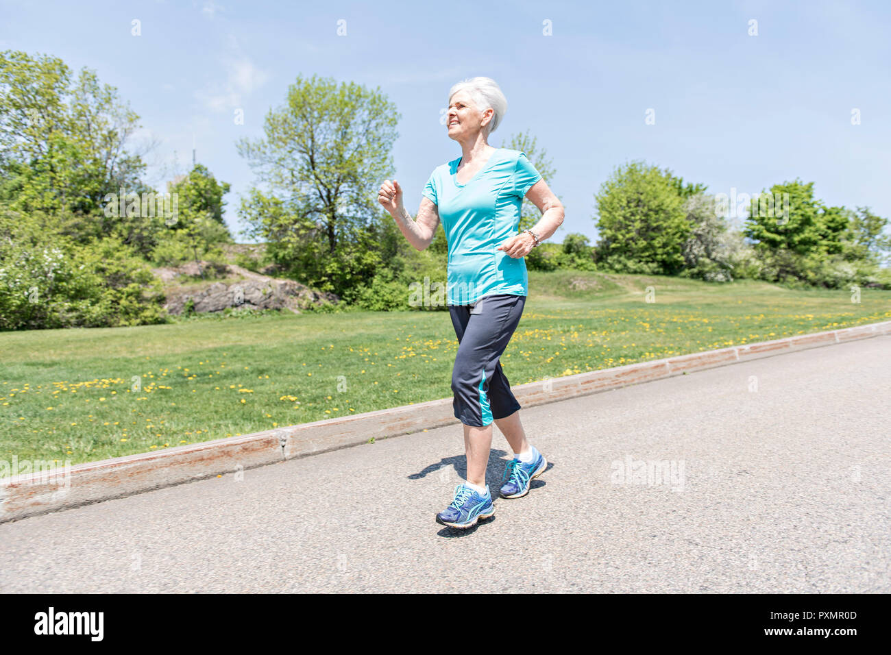 Mature woman jogging autumn hi-res stock photography and images - Alamy