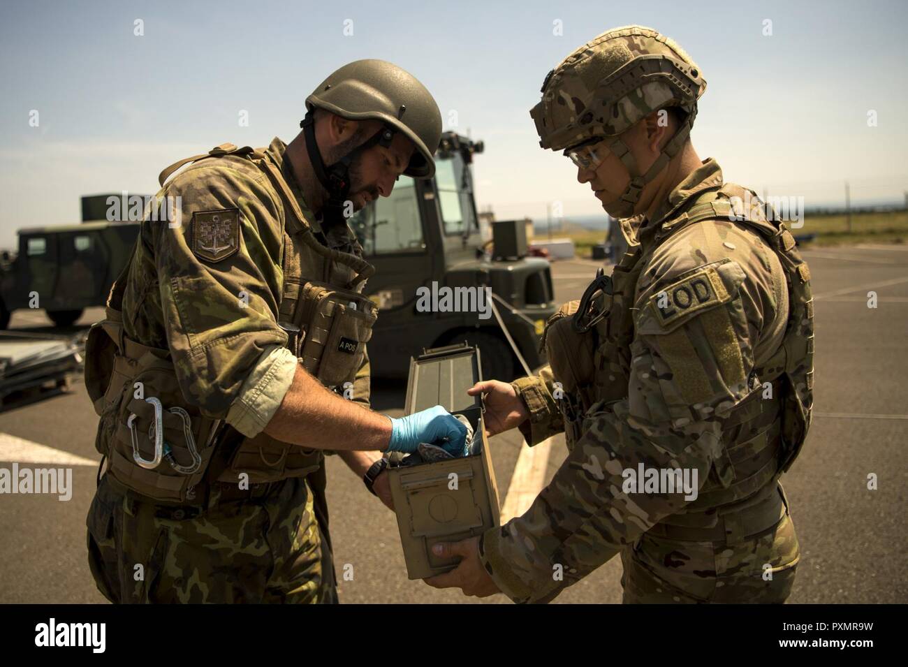 U.S. Air Force Staff Sgt. Arlen Calhoun, 786th Civil Engineer Squadron  explosive ordnance disposal team member, holds an evidence tool box open for  Army of the Czech Republic Sgt. 1st Class Milan, image size:1300x955