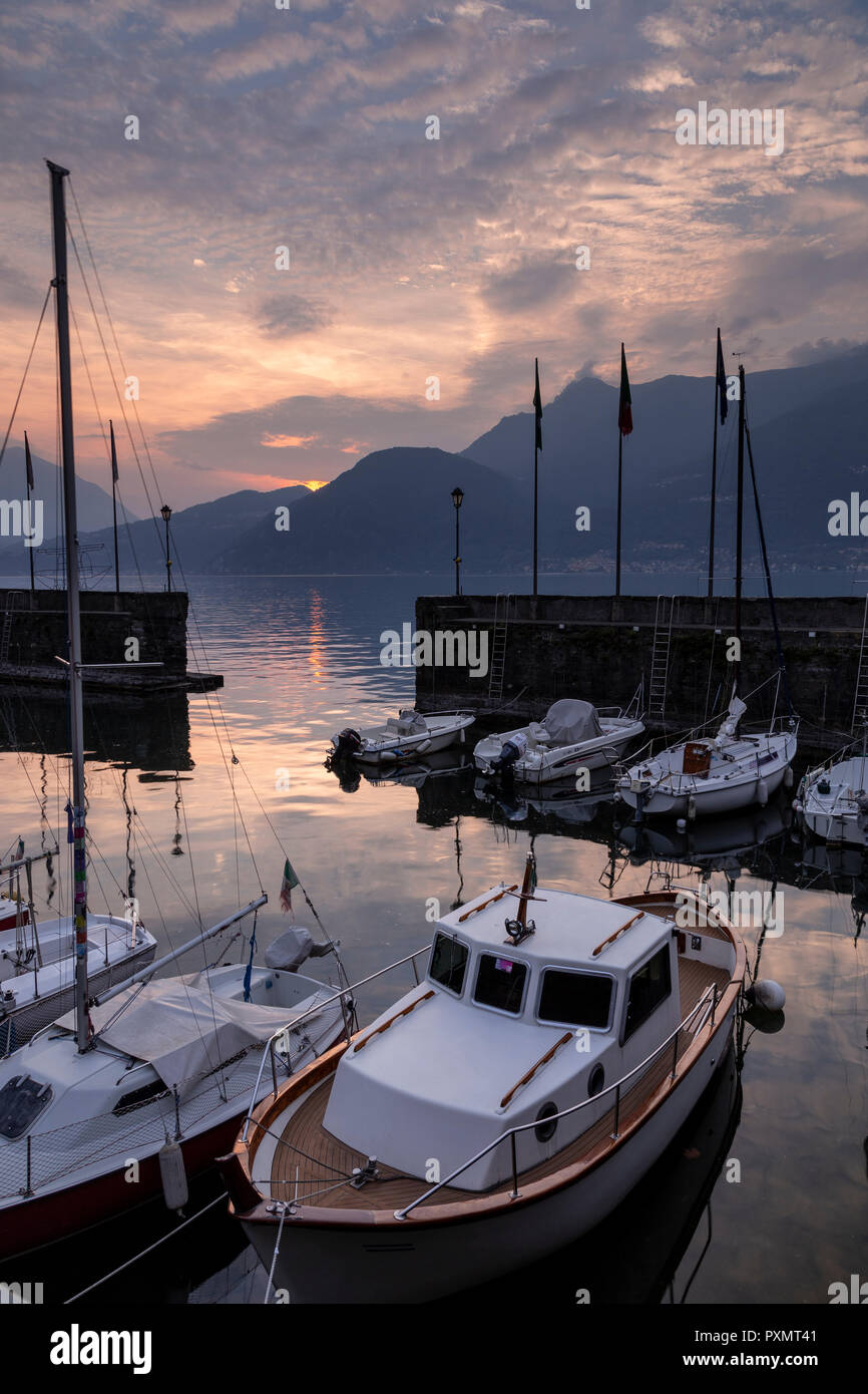 Boats in the harbour at Bellano on Lake Como, Italy at sunset Stock Photo