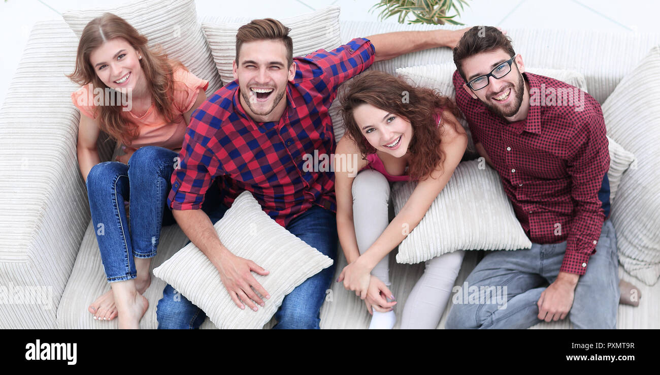 Group Of Friends With Pillows Sitting On The Couch Stock Photo Alamy group-of-friends-with-pillows-sitting-on-the-couch-stock-photo-alamy
