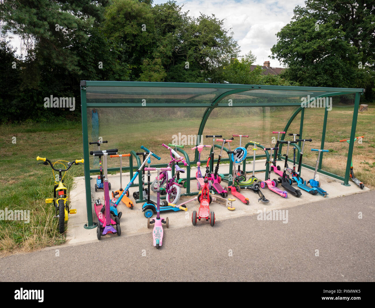 Children's scooters parked up at Worcesters Primary School, Enfield, UK