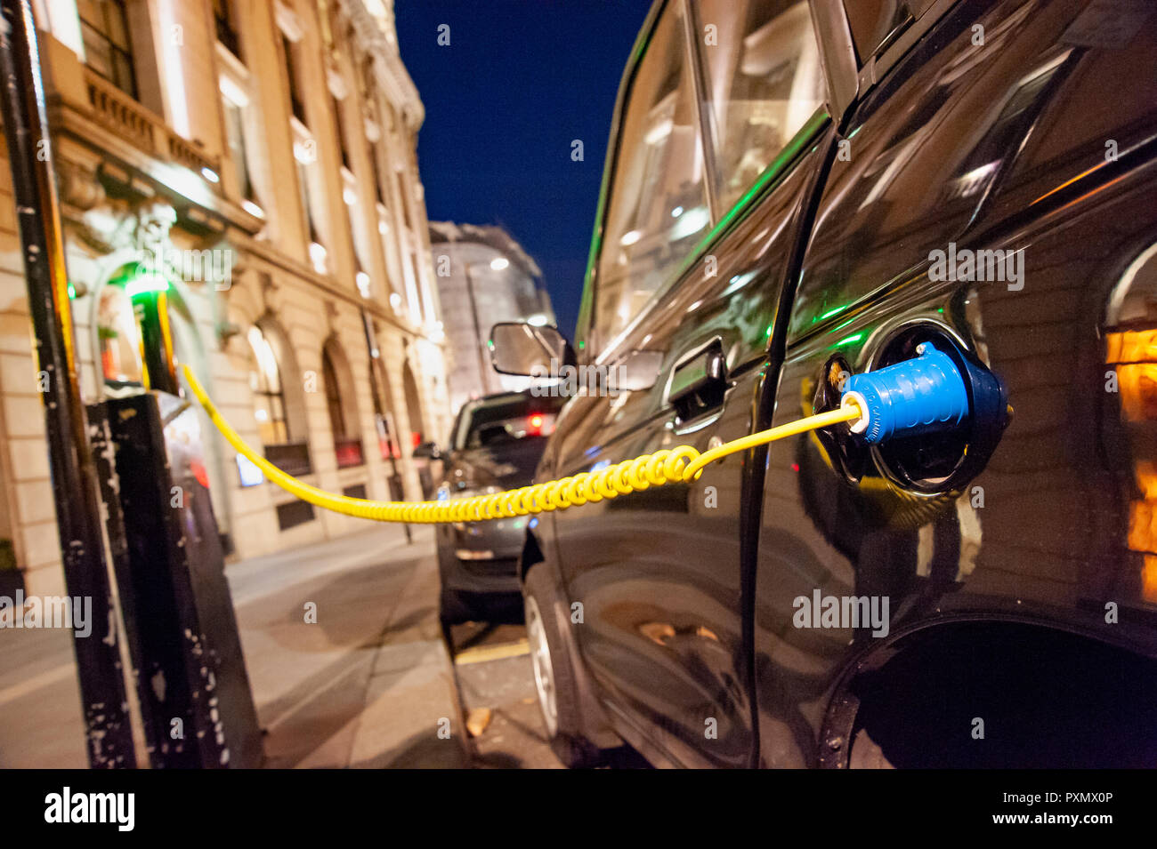 Electric car charging up on a city street charge facility, UK, London Stock Photo