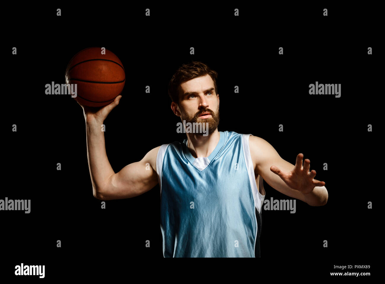 Handsome basketball player shooting ball Stock Photo