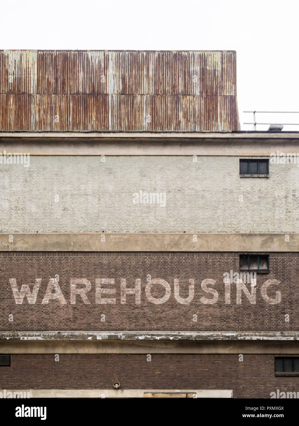 Old brick wall in Rotterdam with the word 'Warehousing' painted on it Stock Photo