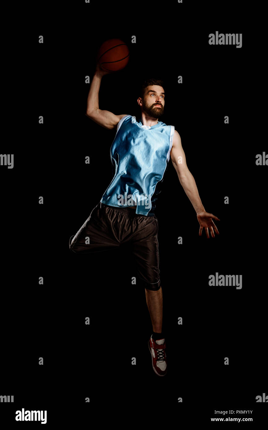 Basketball player jumping to throw Stock Photo Alamy