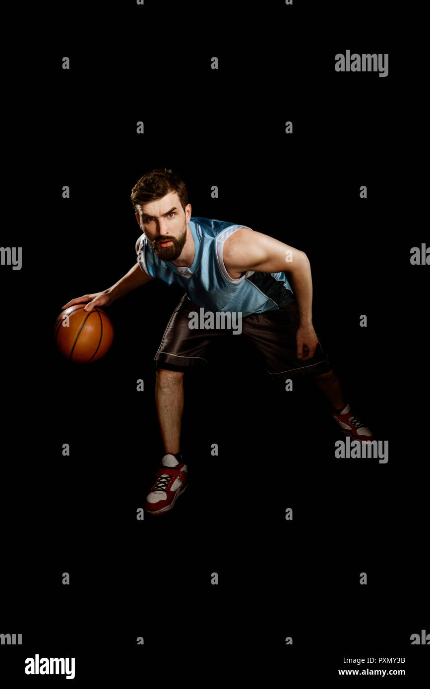 Portrait basketball player dribbling ball hires stock photography and