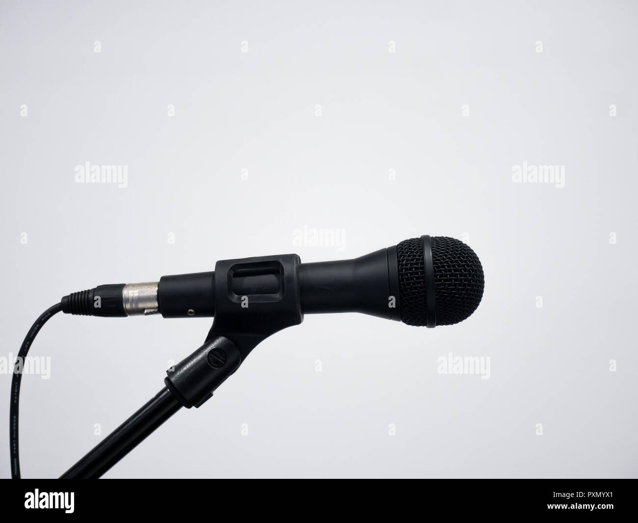 Black wired microphone on stand at white background Stock Photo Alamy