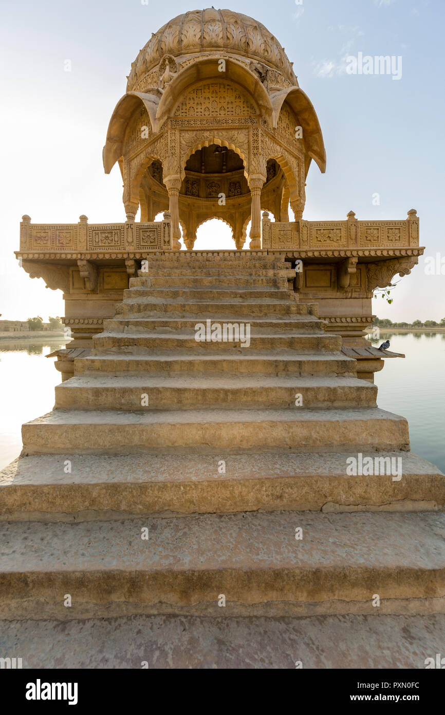 Steps leading to a Chhatri in the middle of Gadisar lake in the desert town of Jaisalmer in India Stock Photo