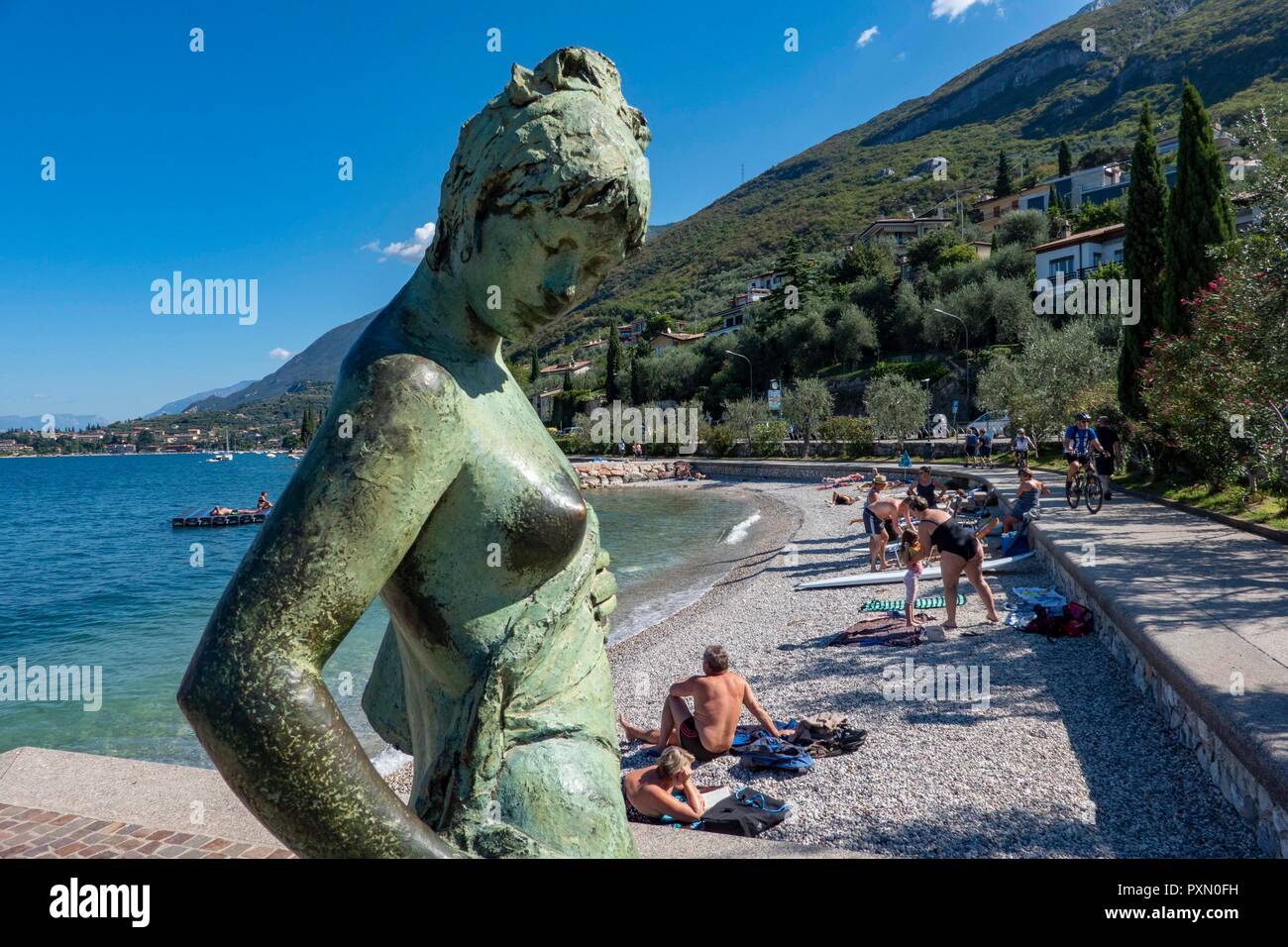 Cassone, Garda Lake, Italy, 09.05.2018. decorative bronce statue by artist Luisa Granera is an eyecatcher at the beach near Cassone. Stock Photo