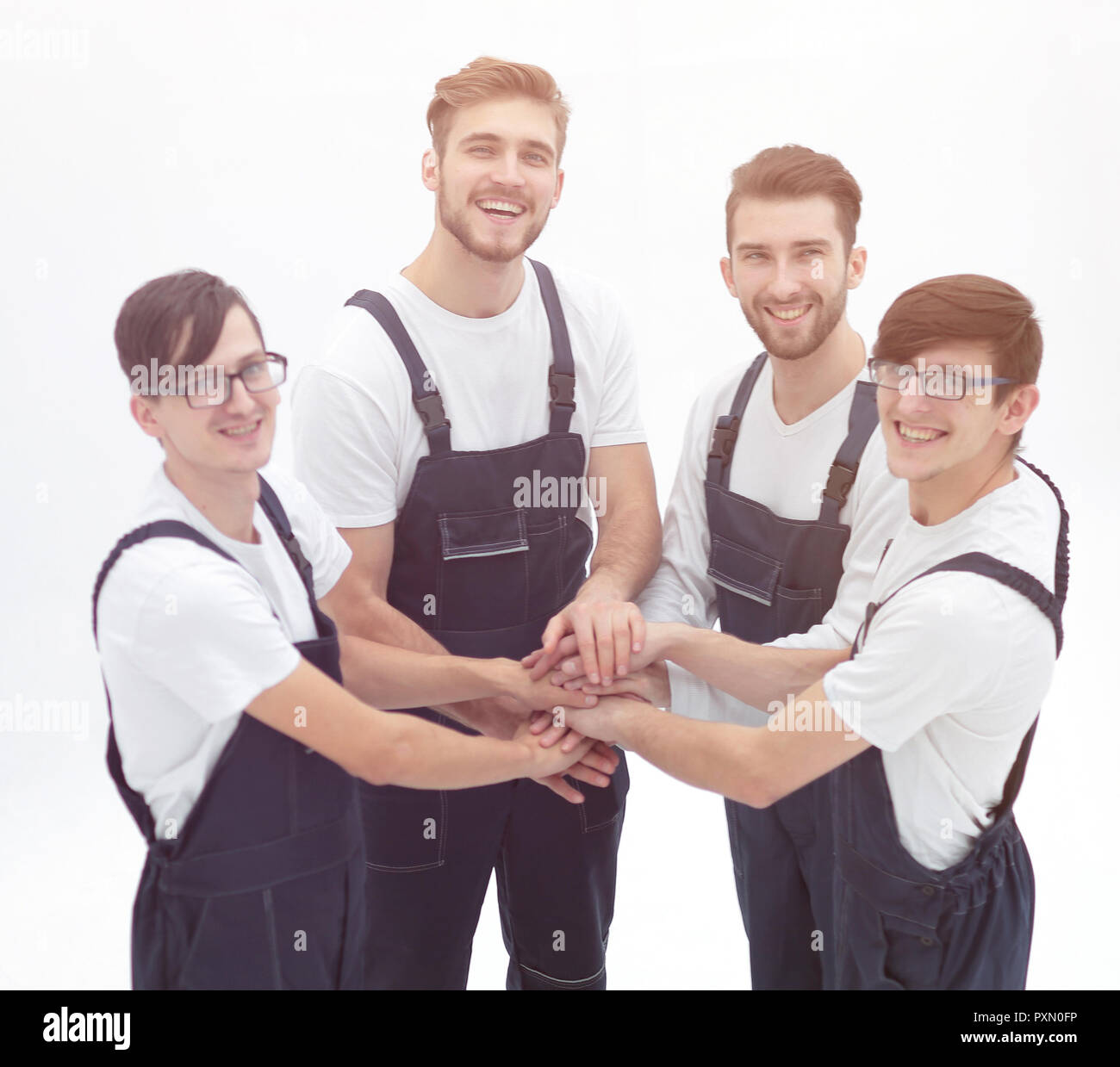 Team of movers joining hands Stock Photo - Alamy