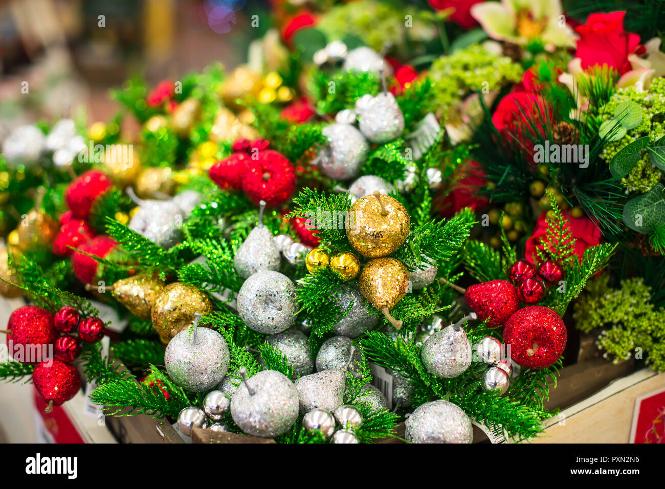 Close up Christmas decoration shiny decorative red, golden and silver apples (malus), pears and fir branches. Interior Decoration. Winter Bouquet. Ver Stock Photo