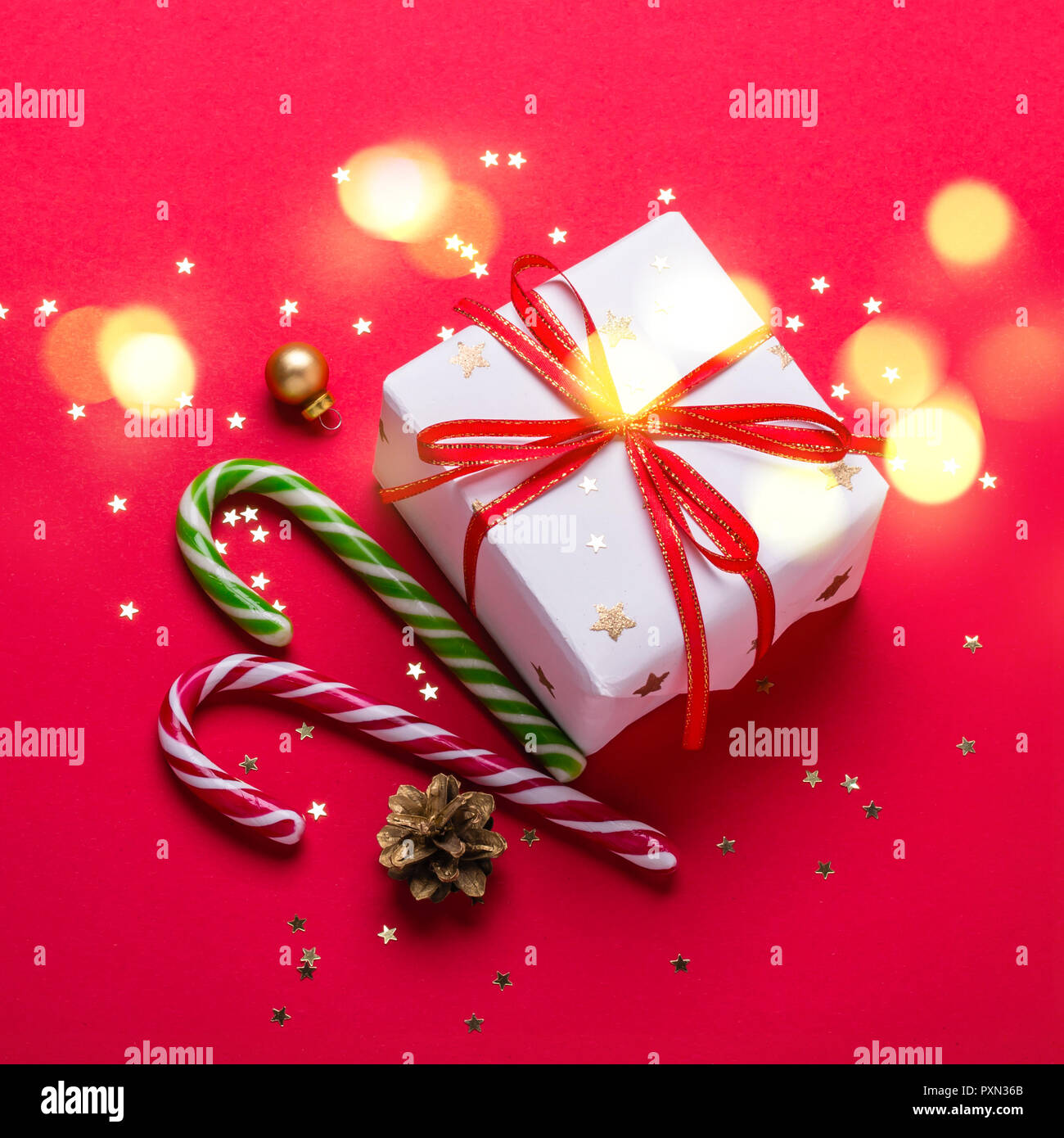 Christmas gift box and candy cane with shining lights Stock Photo - Alamy