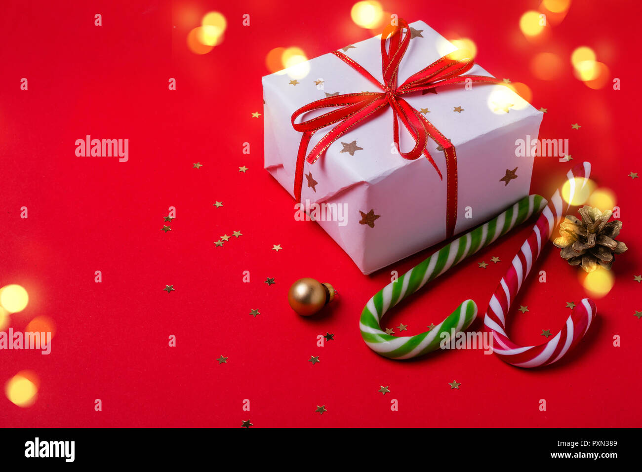 Red Christmas background with Gift box and candy cane Stock Photo - Alamy