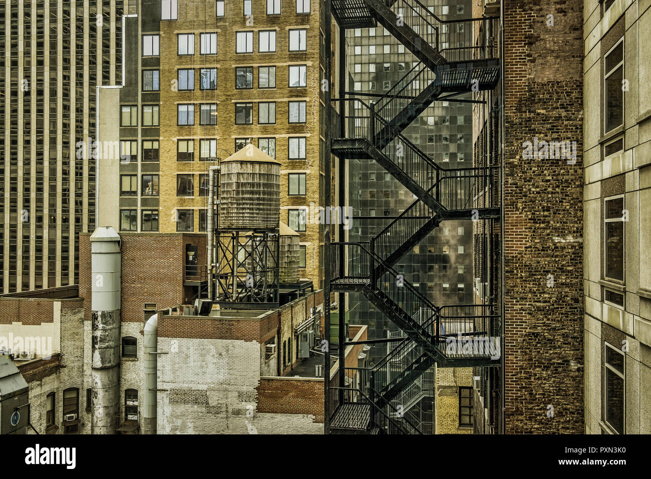 Fire escape and a water tower in the back of a Manhattan building, New York City Stock Photo