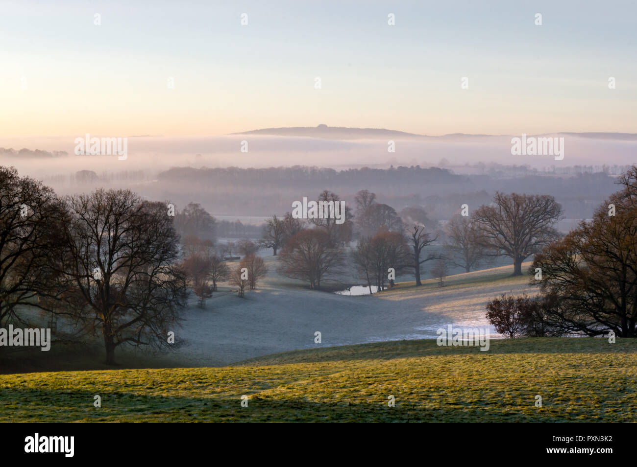 Sunrise Over The English Countryside On A Misty Winters Day Looking Sunrise Over The English Countryside On A Misty Winters Day Looking