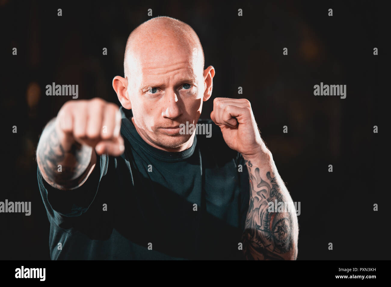 Male MMA Martial Artist fighter punching towards the camera Stock Photo