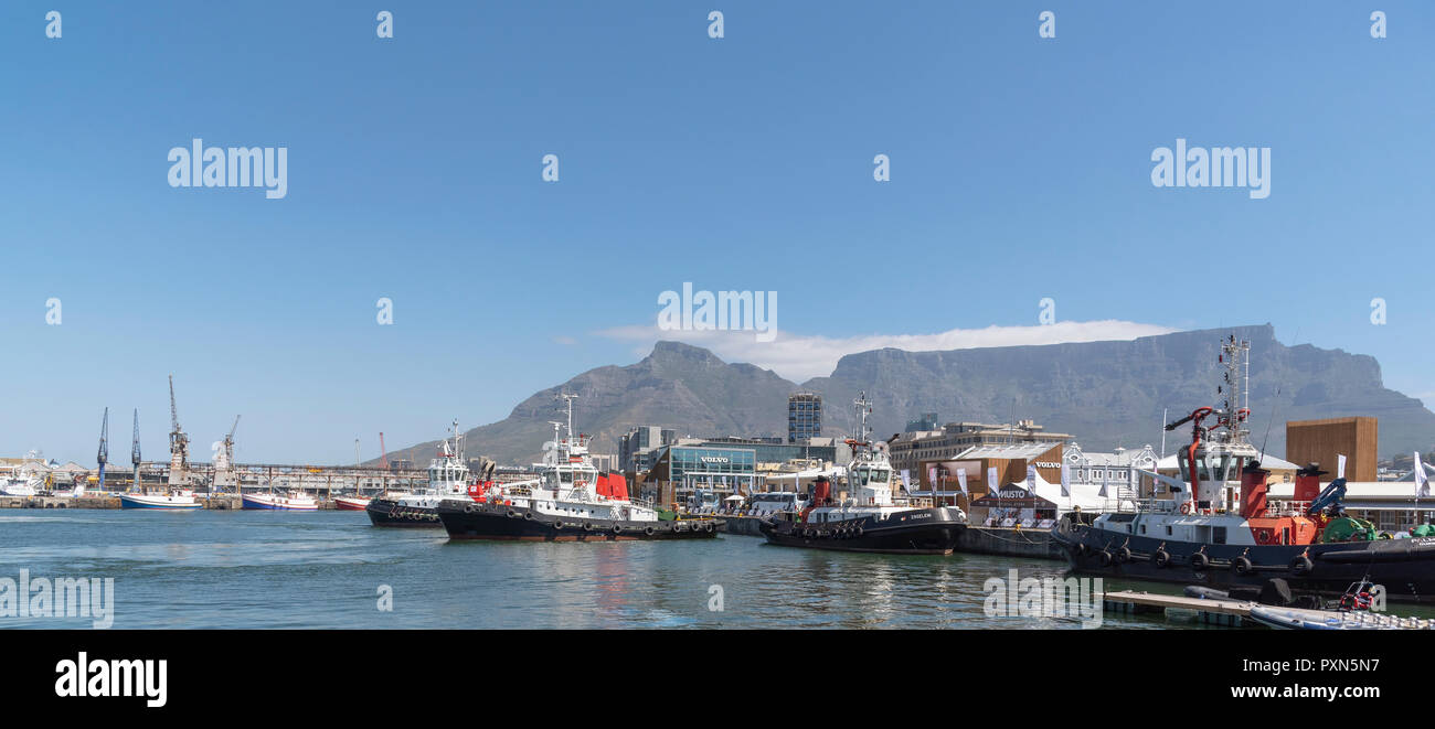 Cape Town, South Africa. Ocean going tugs alongside in the harbour with a backdrop of Table Mountain Stock Photo