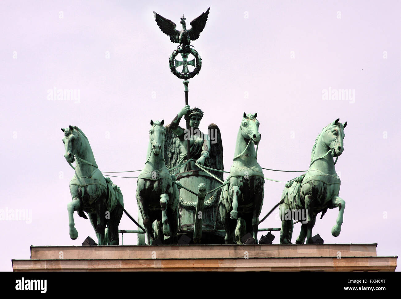 Queen Quadriga, her for horses and chariot. sit on top of the Brandenburg Gate monument in the German city of Berlin. Stock Photo