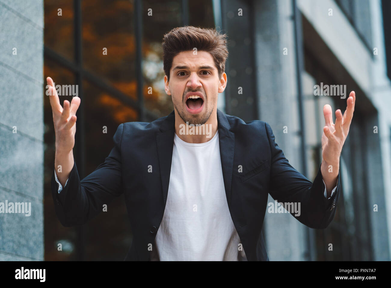 Portrait of angry furious businessman, having nervous breakdown at work ...