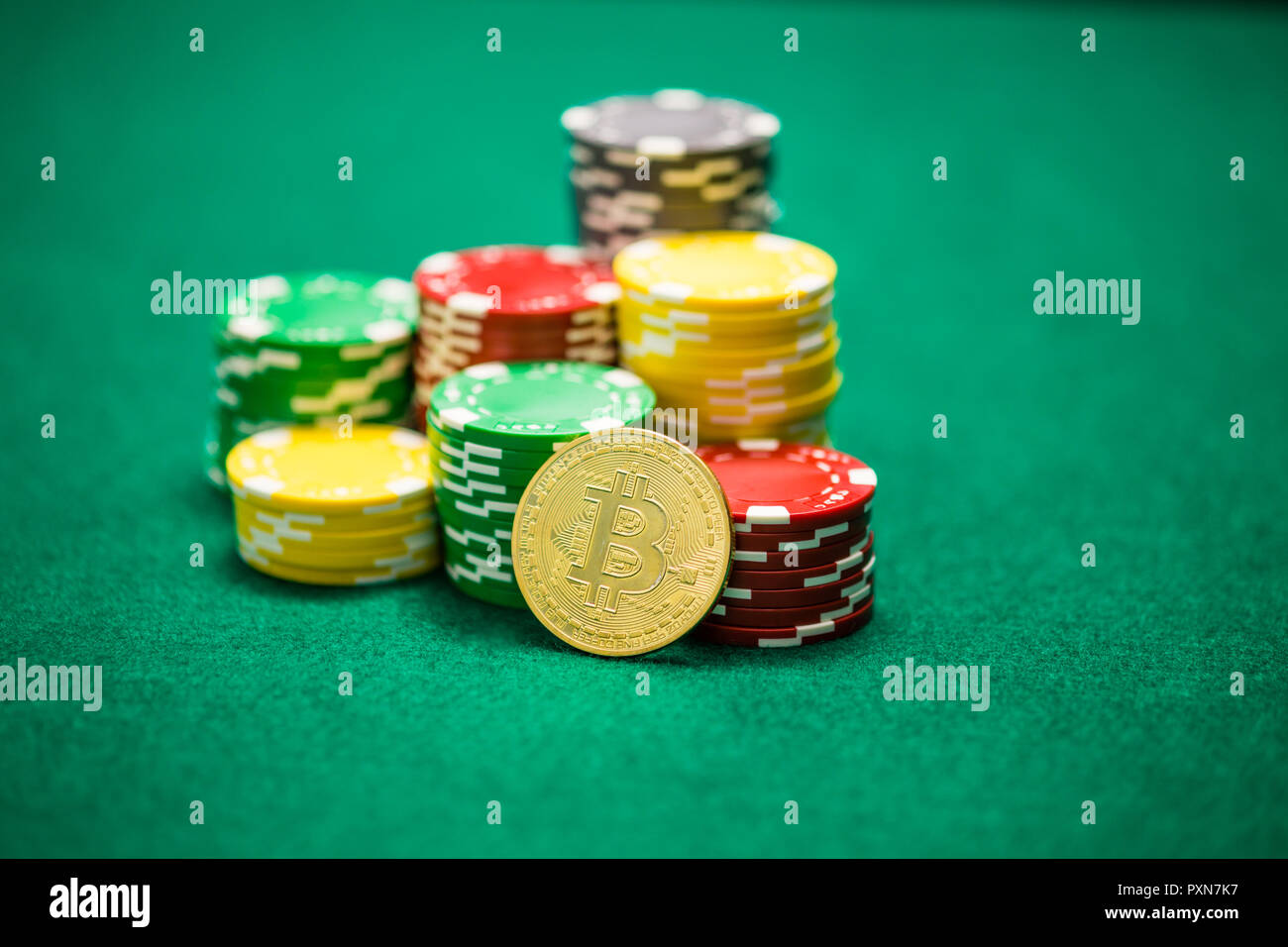 Casino chips and bitcoin on green table, cryptocurrency gambling concept  Stock Photo - Alamy