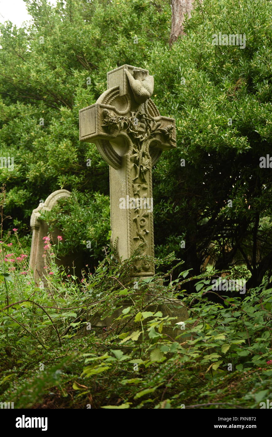 Grave stone in weeds Stock Photo